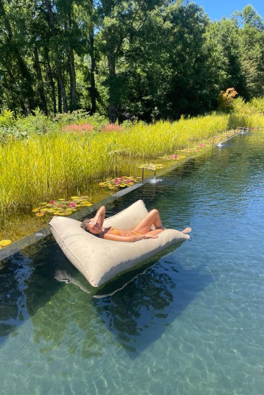 NATURAL SWIMMING POOL - Untreated and naturally balanced, surrounded by lotus blooms and a thriving water garden
