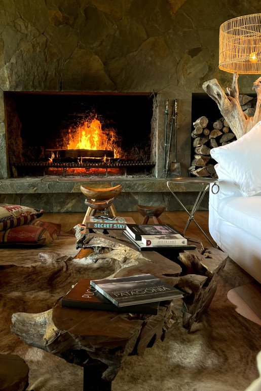 LIVING ROOM – Soft textures, open views, , and rustic charm by the fire