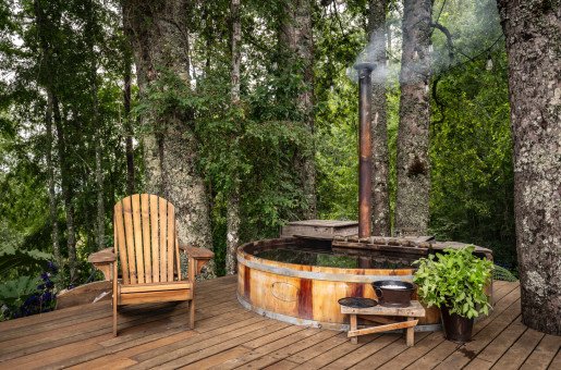 HOT TUB A cozy soak under the trees, warmed by fire, Epsom salts, and herbs.