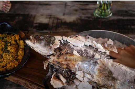 SALT-CRUSTED CATCH - Whole fish encased in sea salt, grilled to perfection—a tribute to Chile’s seafood heritage